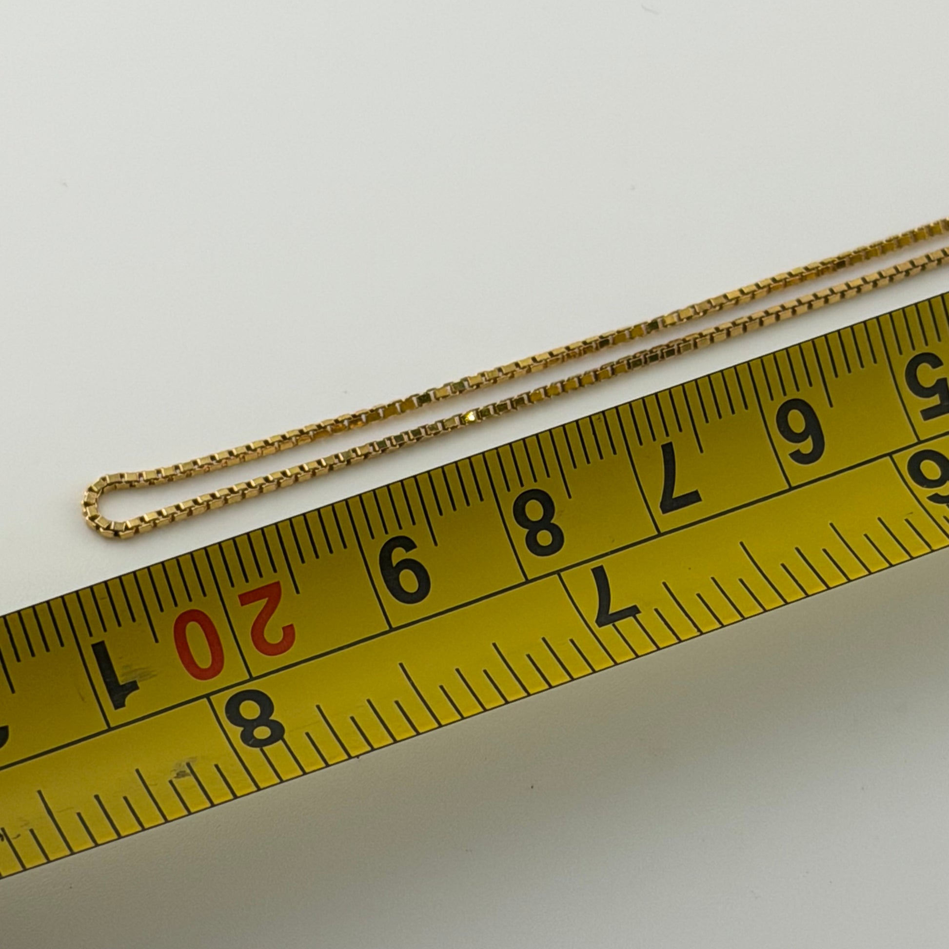 9ct gold box chain, 1mm wide, 18in long, hallmarked, 2.7g, shown with measuring tape.