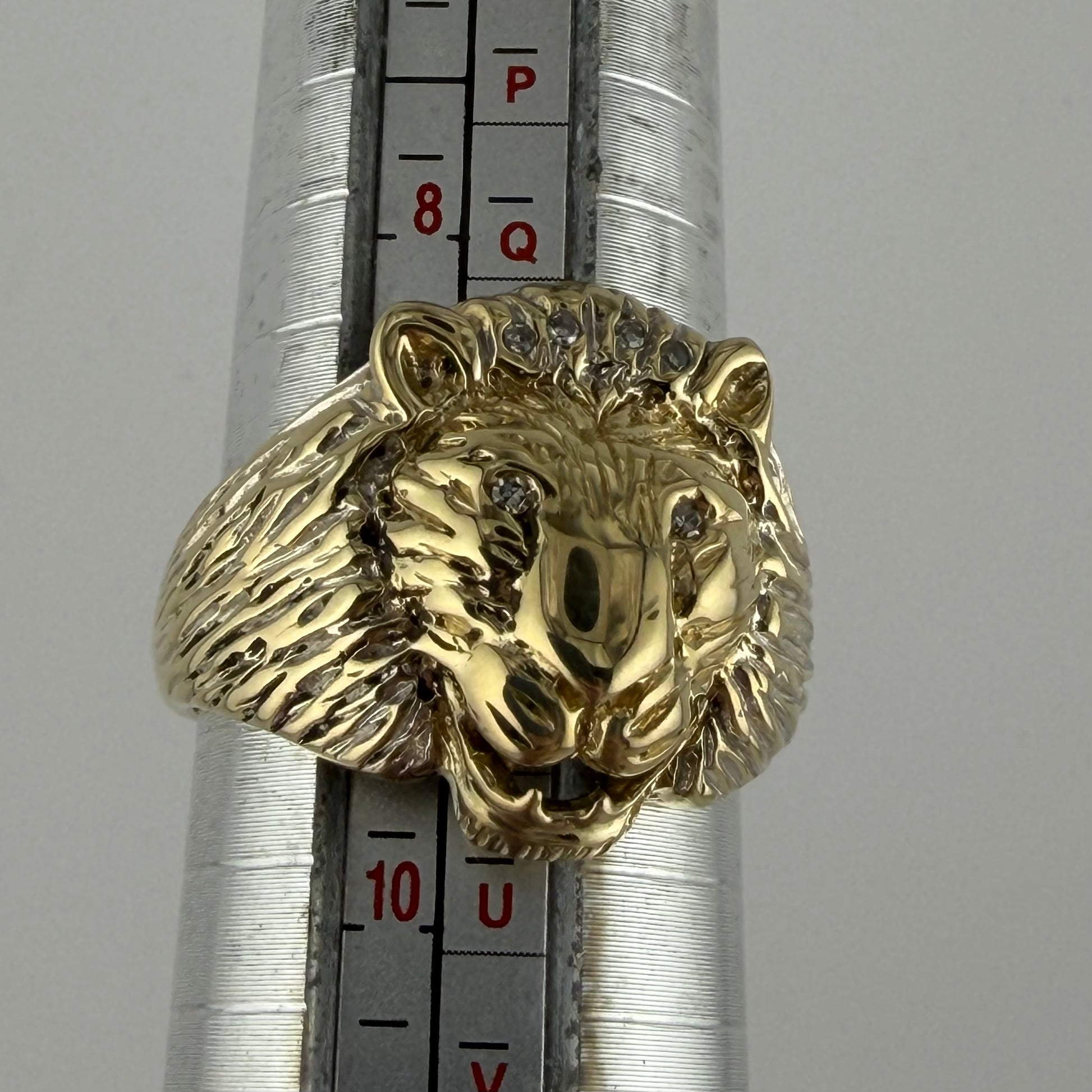 9ct gold diamond lion head gents ring size S, hallmarked 8.35g, detailed mane and eyes, on ring sizer.
